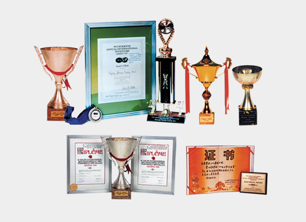 A collection of trophies, framed certificates, medals, and awards arranged in two rows, showcasing various achievements and recognitions.