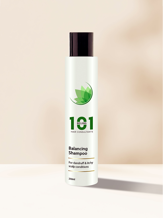 A bottle of Beijing 101 Balancing Shampoo 250ml, white with a black cap, stands upright on a light surface; the label indicates it is formulated for dandruff and itchy scalp conditions.